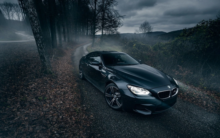 BMW m6 with its lights on the road