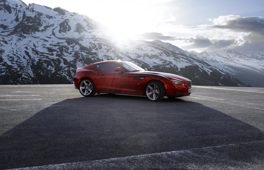 BMW Zagato is on the background of snowy mountains and is illuminated by sunlight