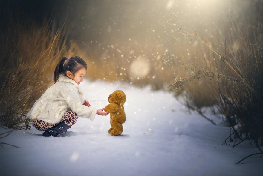 Girl greets a teddy bear