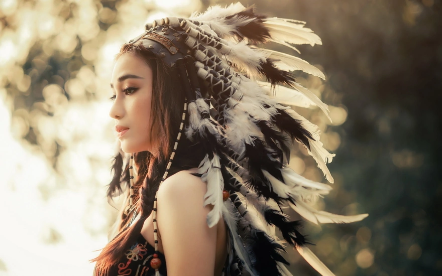 Girl in a headdress of feathers