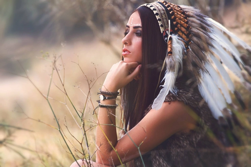 Girl in an Indian hat with feathers