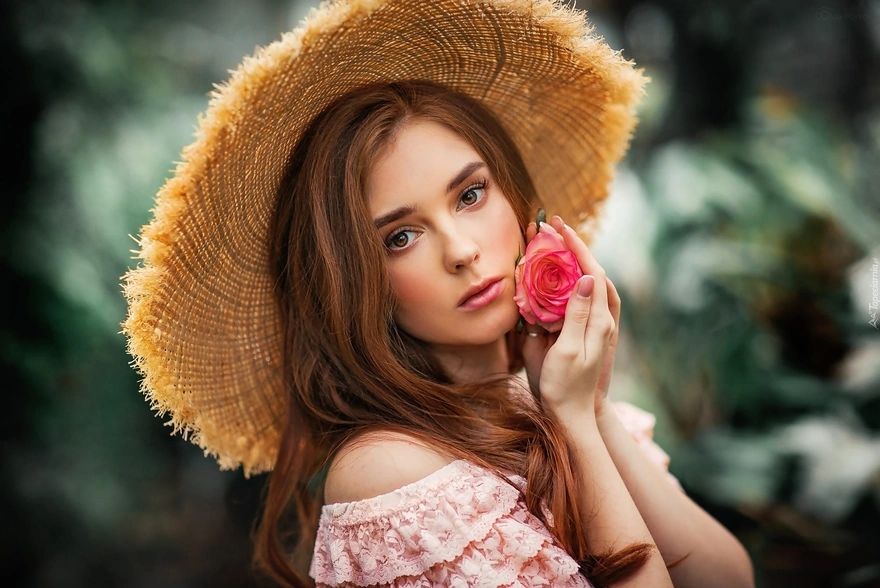 Girl in a straw hat with a rose