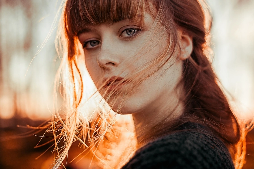 Beautiful looking girl with developing hair in the wind