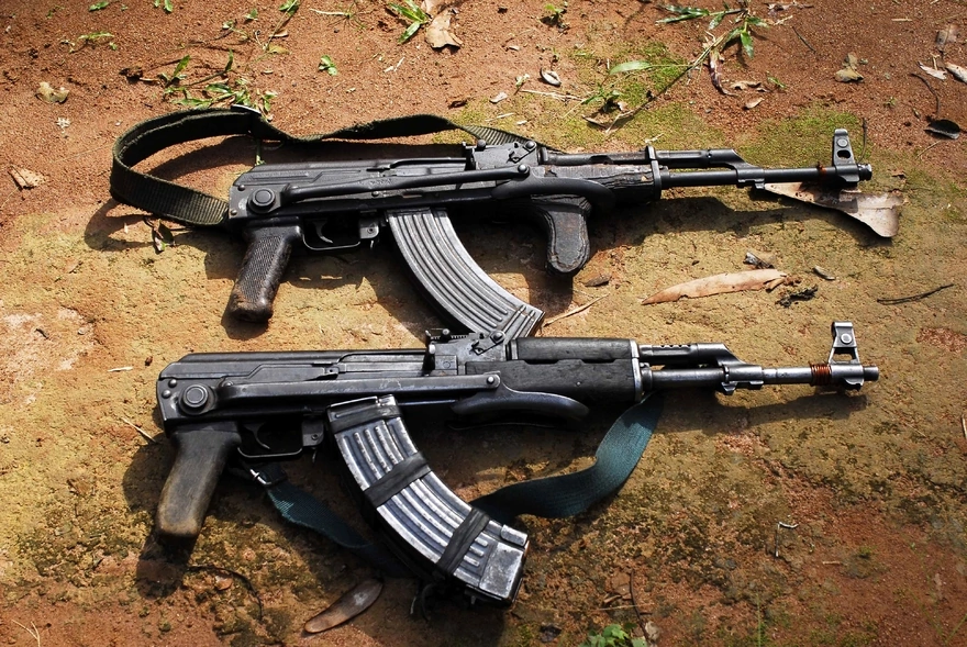 Two Kalashnikov assault rifles lie on the ground
