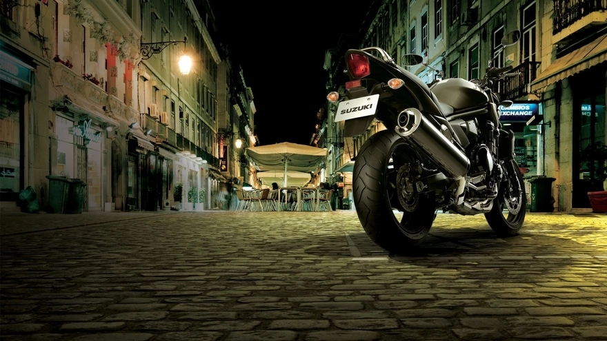 Black Suzuki is night on a city street