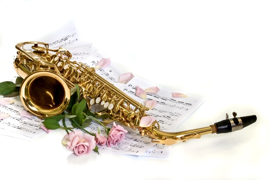 Saxophone lying on sheet music