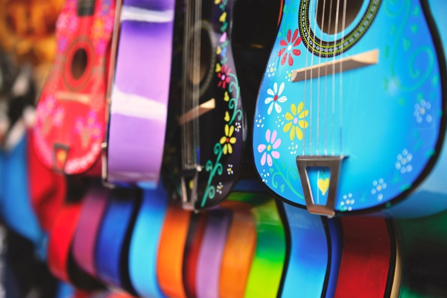 Assortment of colored guitars with painted flowers