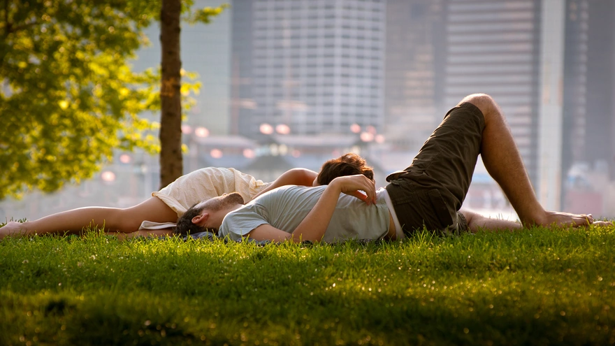 A couple enjoying a day at the city's green lawn