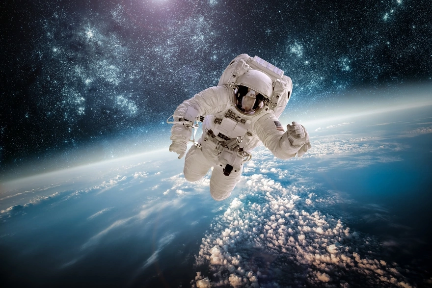 Astronaut in zero gravity above the Earth