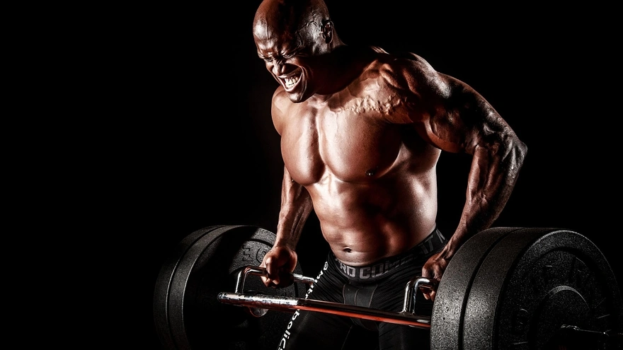 The bodybuilder lifts the barbell