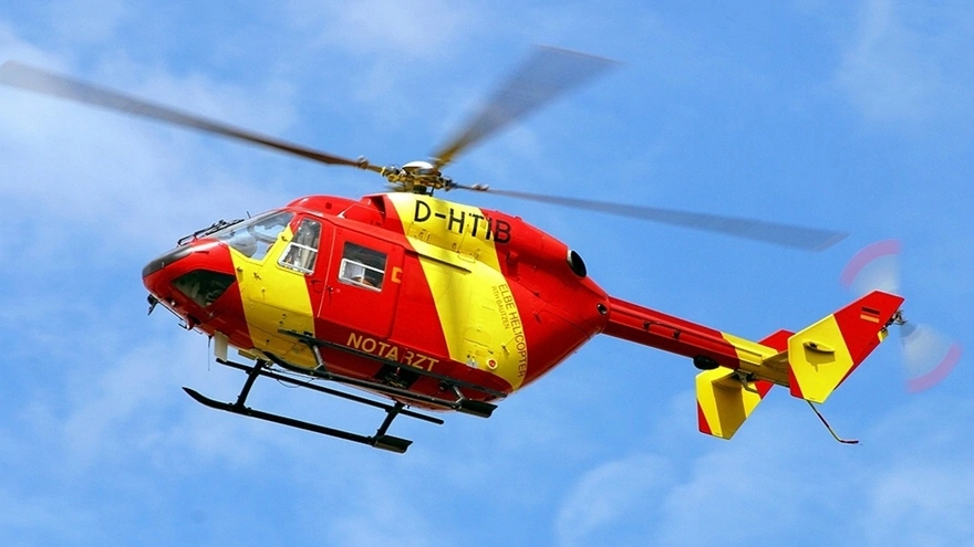 Helicopter yellow-red color flying in the sky