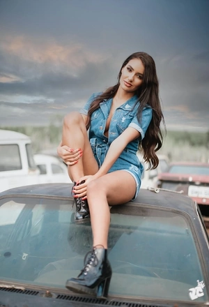Image: Brunette, smile, legs, boots, hair, sitting, car, roof, sky, weather