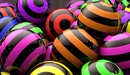 Image: Many multi-colored striped balls.