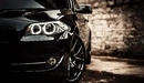 Картинка: Передняя часть чёрного BMW M5. 