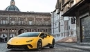 Image: Yellow Lamborghini Huracan Coupe in the background of old buildings.