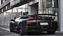 Картинка: Lamborghini Murcielago SV стоит у тротуара.