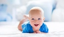 Image: Blue-eyed baby smiling.