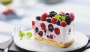 Image: A delicious slice of cake with berries.