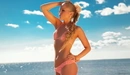Image: Blonde in a knit bikini at the sea.