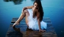 Image: Girl in white tutu sitting on the dock.