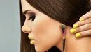 Image: Girl with bright makeup and manicure shows massive earrings