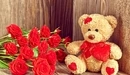 Image: Teddy bear with a heart and roses.