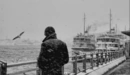 Image: A man on the pier in winter