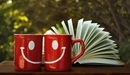 Image: A couple of smiling mugs.