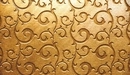 Image: Golden background with a pattern of swirls
