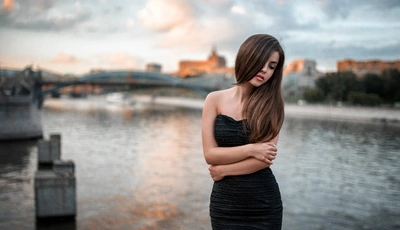 Image: Girl, river, bridge, brunette, standing, black dress, hair, washed out