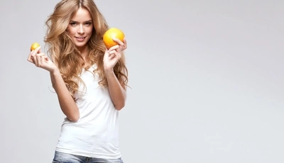 Image: Girl, blonde, smile, hair, holding, orange, tangerine