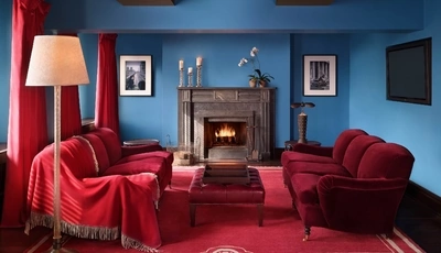 Image: Living room, red color, fireplace, floor lamp, sofa