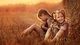 Картинка: Две девочки в поле у стога сена гладят и обнимают котят