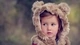 Image: Girl in a vest with ears of a bear looking to the side