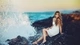 Картинка: Девушка сидит на камнях у моря
