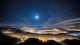 Image: The night sky above the town covered with fog