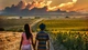 Image: A couple in love is walking through a field along the road towards the distant horizon