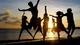 Картинка: Компания друзей веселятся на берегу моря при закате