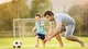 Картинка: Отец с ребёнком играют в футбол