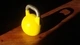 Image: Yellow dumbbell on a wooden floor