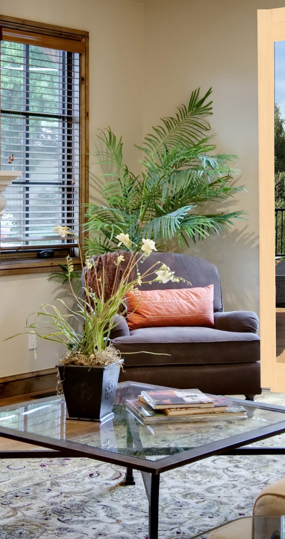 Image: Fireplace, table, sofa, window, blinds, plants, painting, terrace