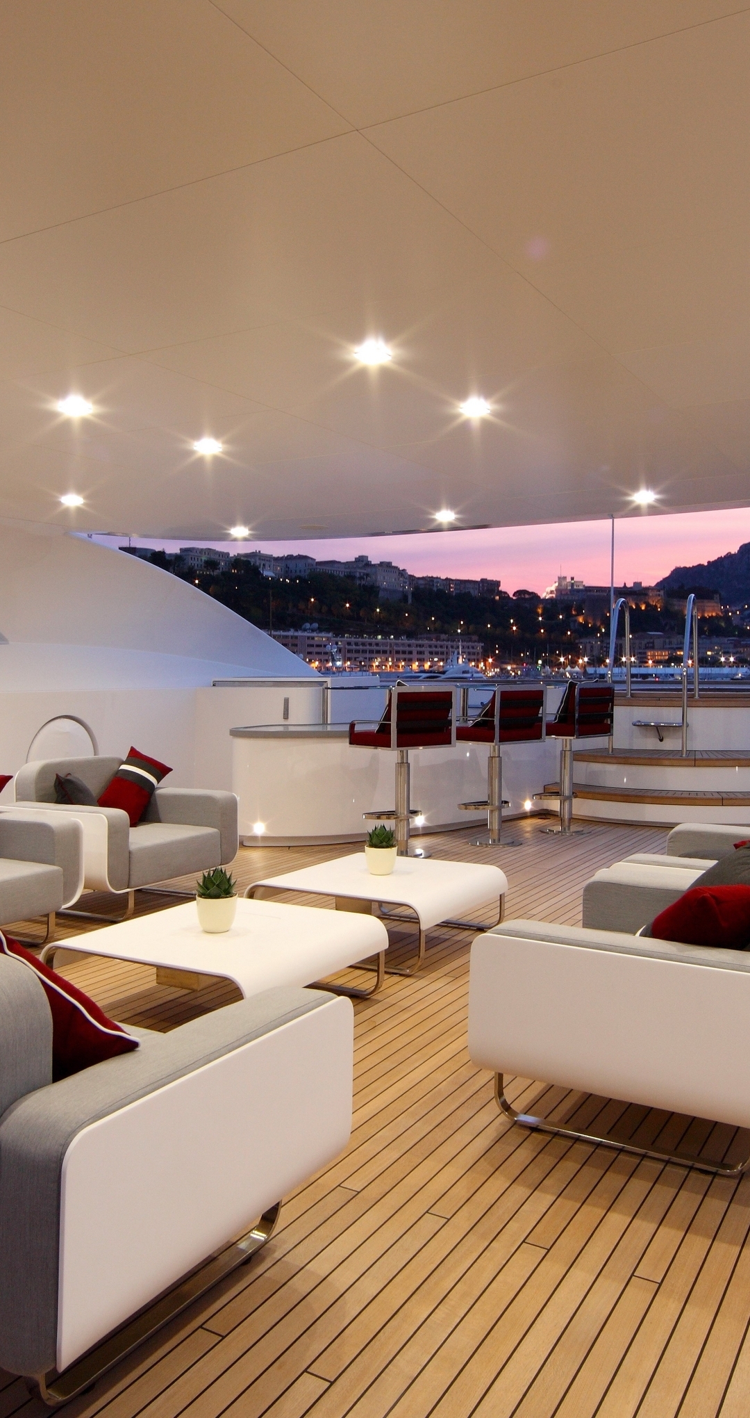 Image: A yacht, a couch, chairs, tables, bar stools, lights, night
