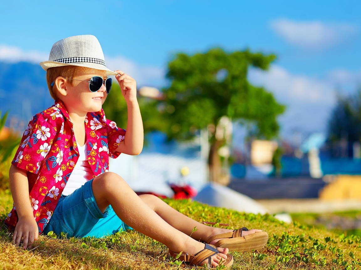 Image: Boy, sitting, sunglasses, hat, summer, grass, sun rays