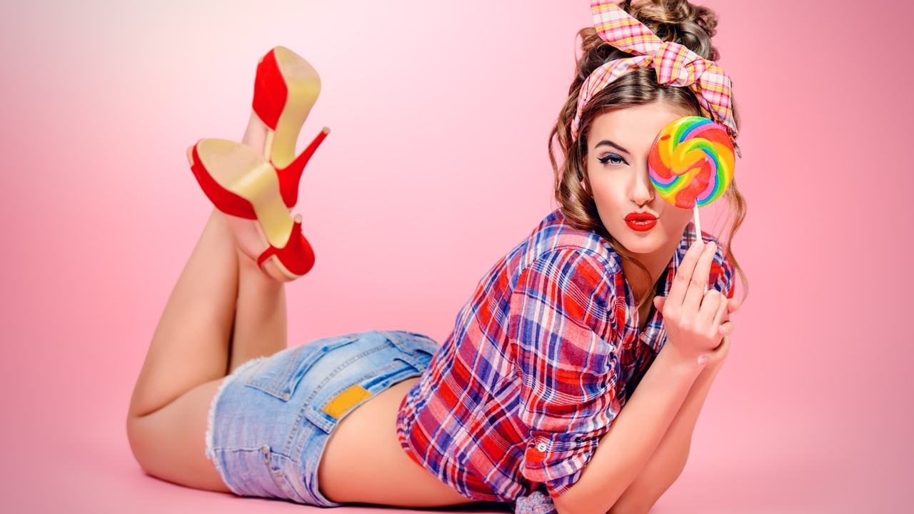 Image: Girl, squints, caramel, style, laying, shoes, feet, shirt, pink background