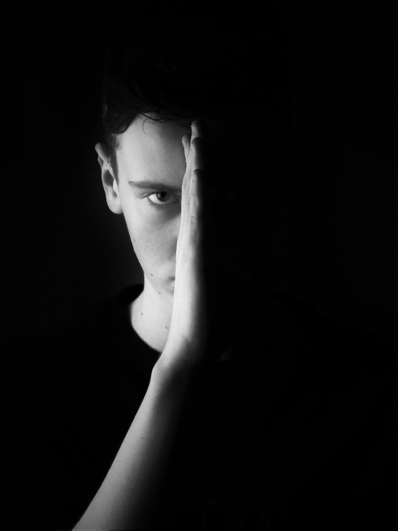 Image: Male, man, face, hand, dark, black background