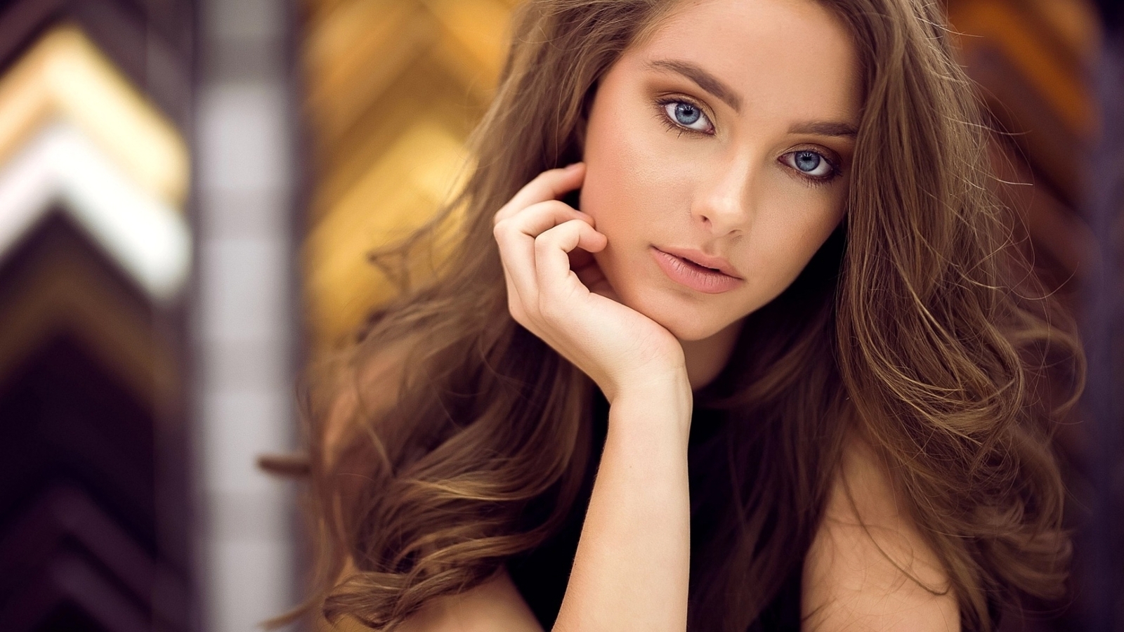 Image: Girl, brown hair, blue eyes, face, hand near a face