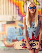Image: Blonde, glasses, smile, skateboard, blurring, graffiti