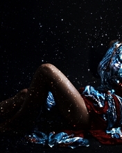Image: Girl, brunette, sitting, dress, dark background, snowflakes, light