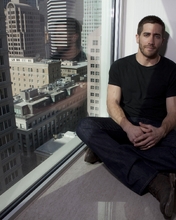 Image: Jake Gyllenhaal, actor, man, sitting, window sill, skyscraper, building