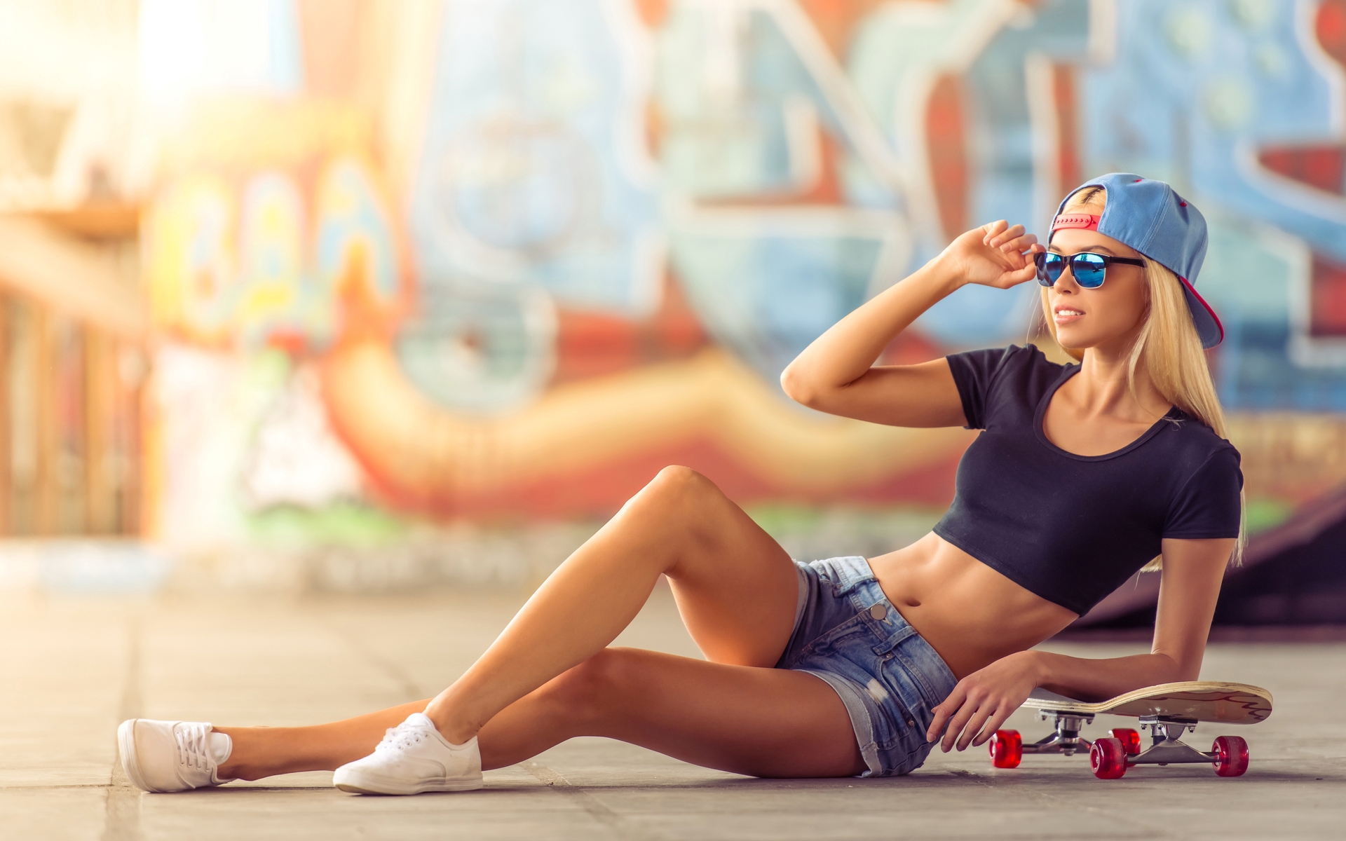Image: Girl, blonde, cap, glasses, lies, skateboard, graffiti